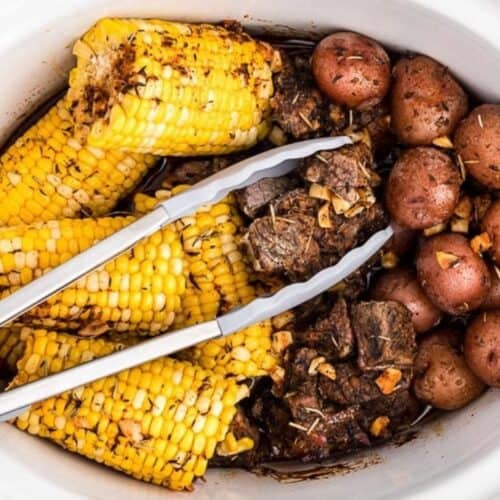 Steak potatoes and corn in slow cooker.