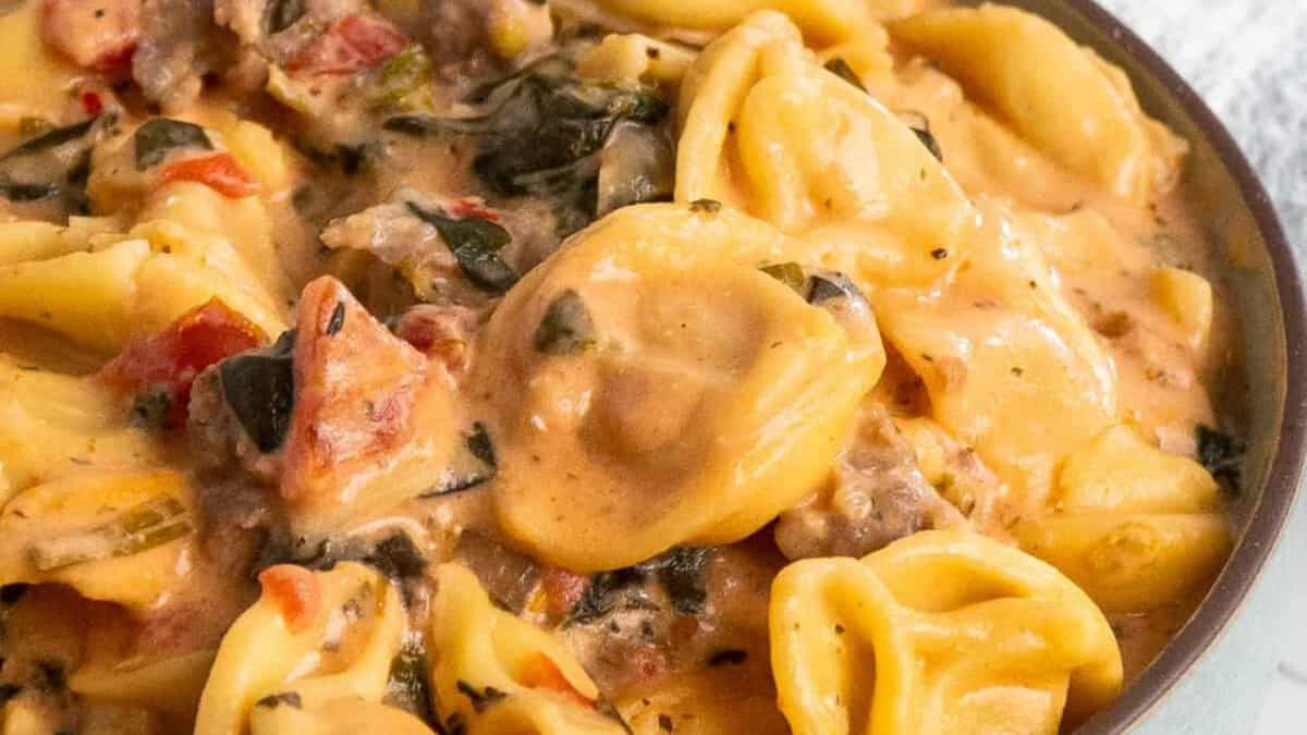 A bowl filled with Creamy Crockpot Tortellini.