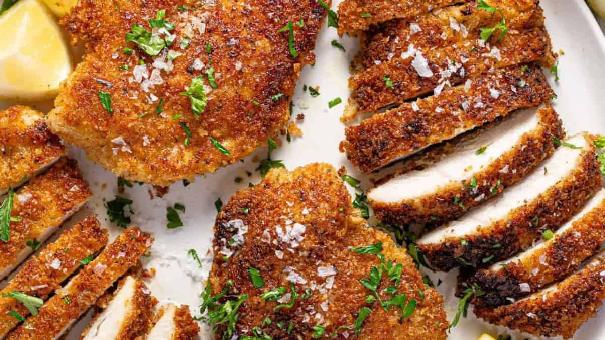 Sliced panko crusted chicken on a plate.