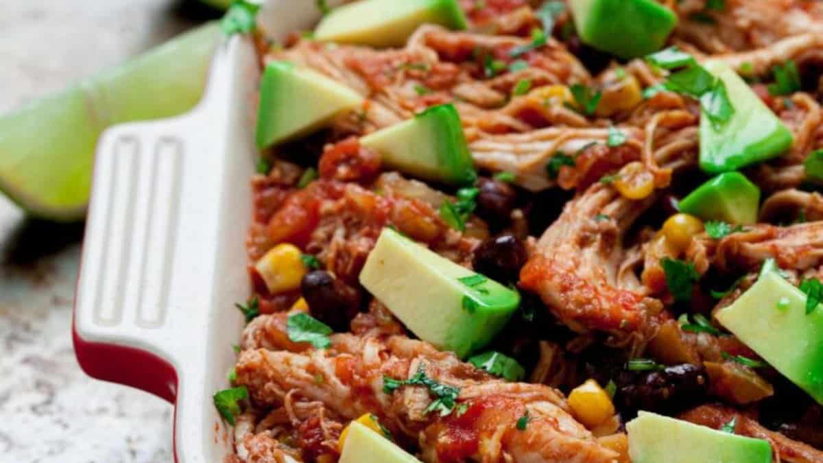 Crockpot chicken salsa topped with avocados.