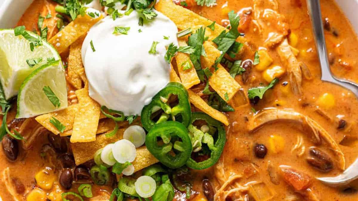 A bowl of creamy chicken enchilada soup.