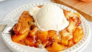 Peach cobbler with ice cream.