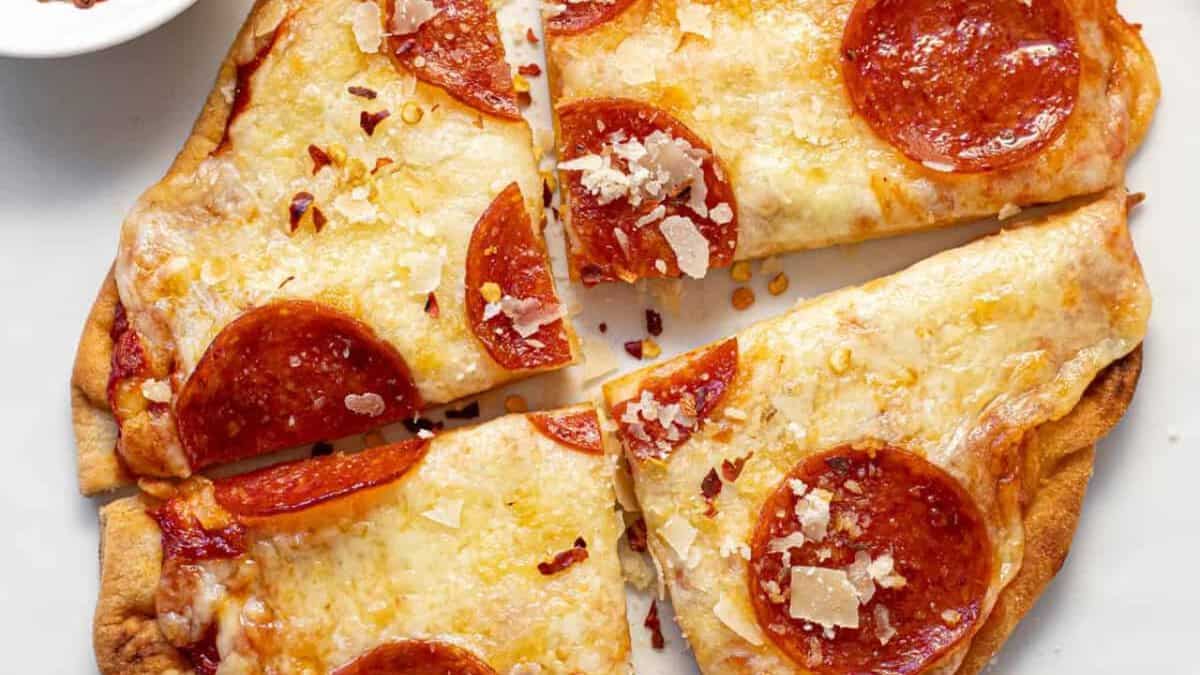 Slices of naan pizza with cheese and pepperoni.