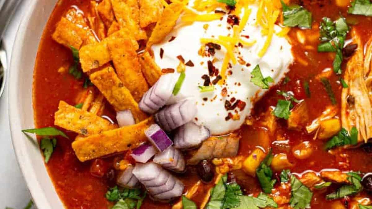 Chicken tortilla soup topped with cream.