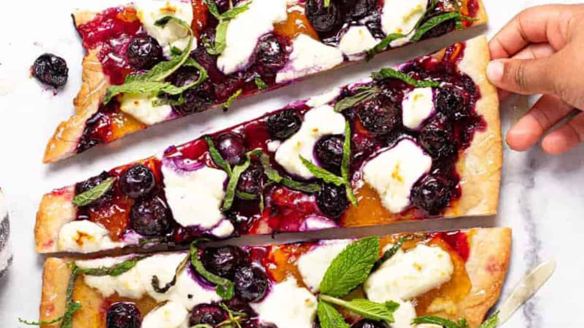 Slices of https://midwestfoodieblog.com/blueberry-flatbread-with-goat-cheese/.