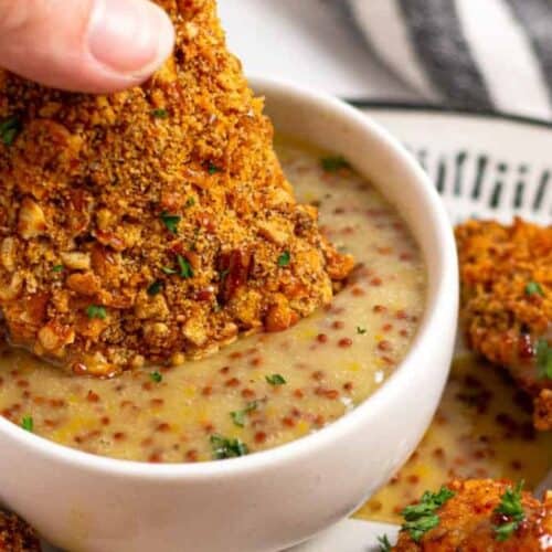 Dipping a chicken tender.