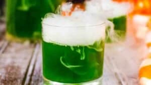 A green cocktail with smoke.