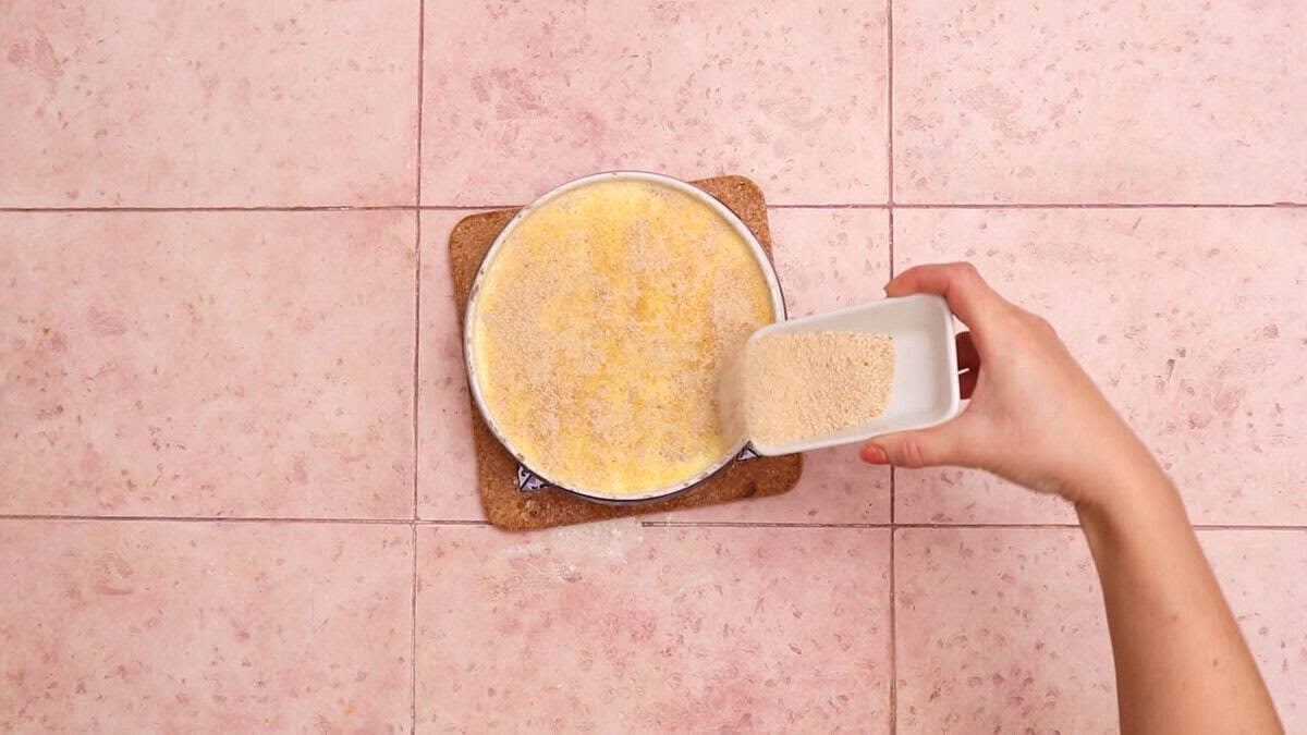 Adding breadcrumbs to brie mac and cheese before baking.