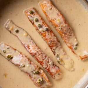 Salmon piccata in a skillet.