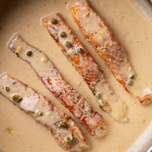 Salmon piccata in a skillet.