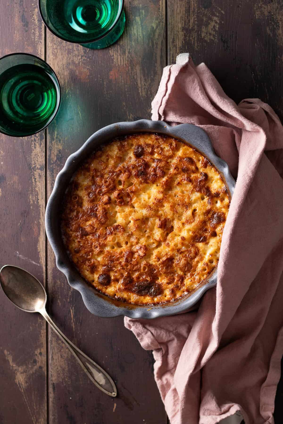 Easy baked truffle mac and cheese in a round baking dish with golden top.