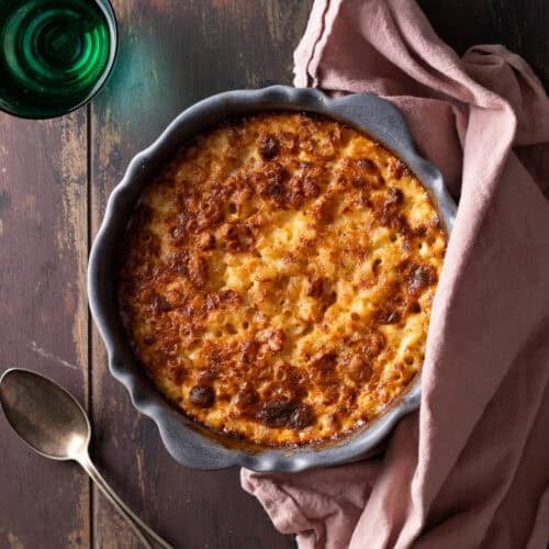 Easy baked truffle mac and cheese in a round baking dish with golden top.