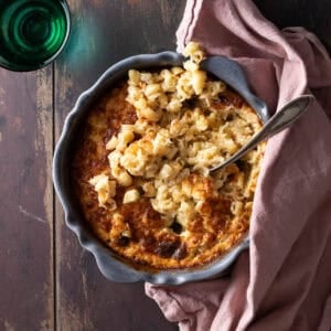 Easy baked truffle mac and cheese in a round baking dish with golden top.