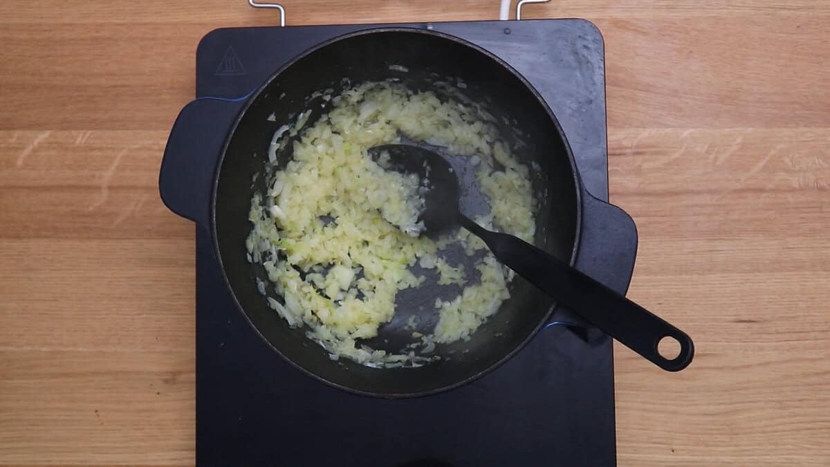 Sauteing onions and garlic in a pot.