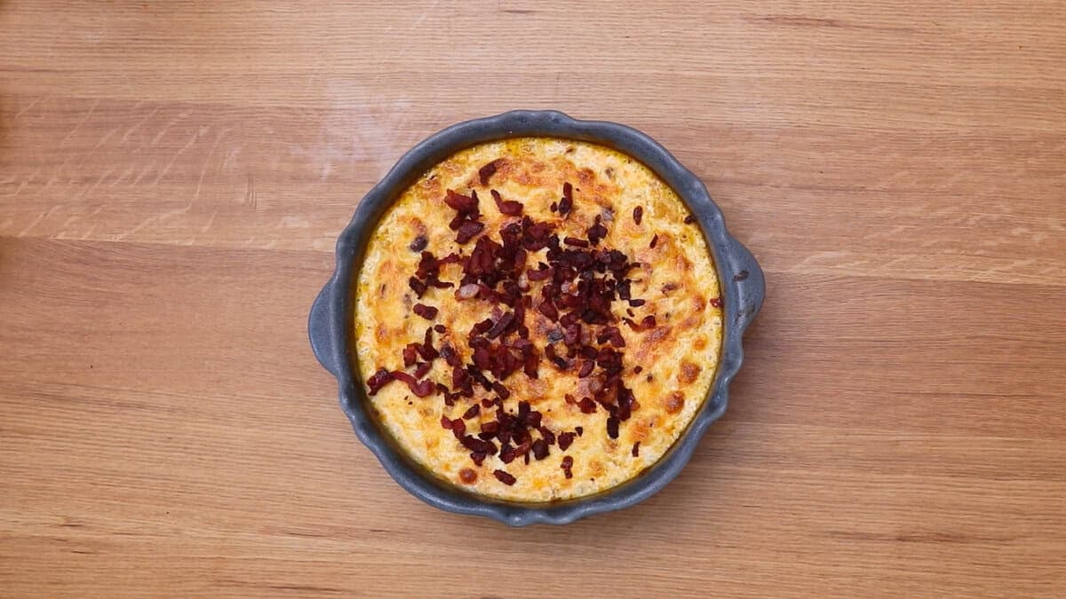 Bacon mac and cheese after baking, topped with crispy bacon.