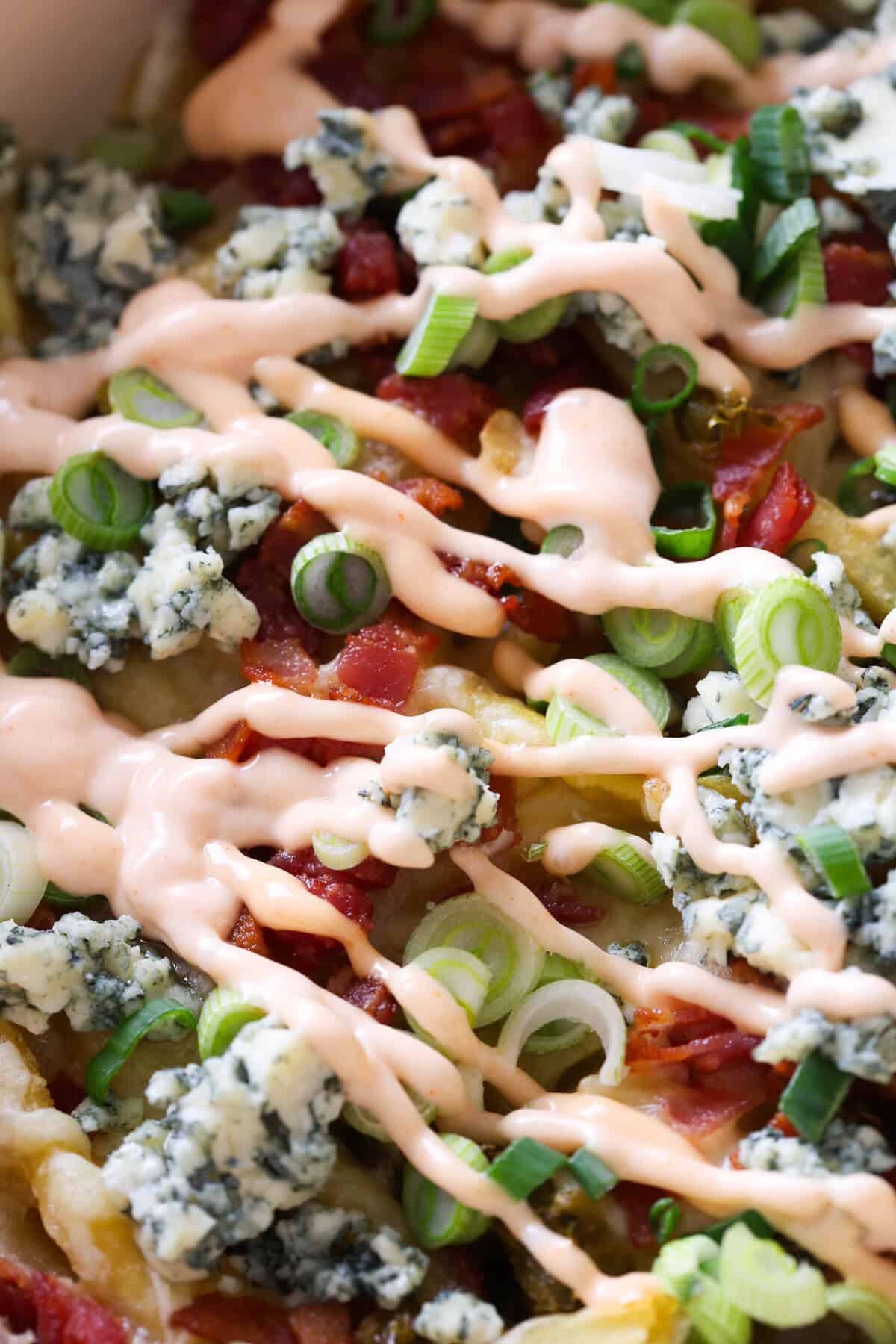Buffalo fries topped with buffalo dipping sauce.