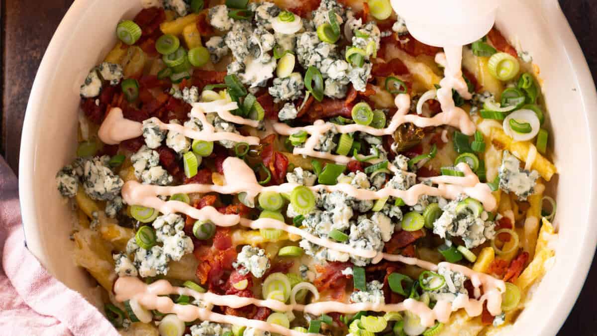 Buffalo fries topped with buffalo dipping sauce.