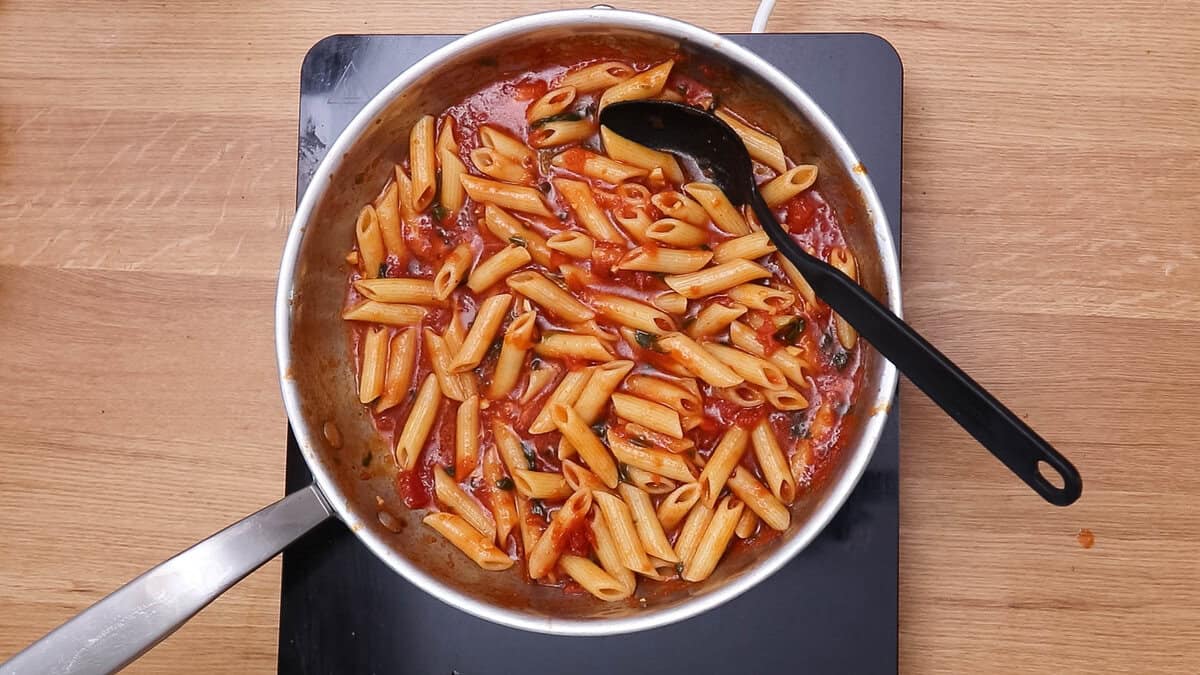 Penne pomodoro or pasta with tomato basil sauce in a pan after cooking.