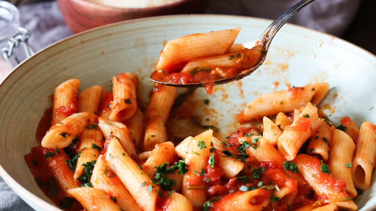 A bowl with penne pomodoro (pasta with basil tomato sauce).