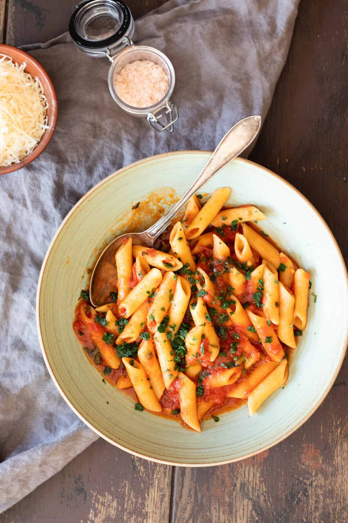 A bowl with penne pomodoro (pasta with basil tomato sauce).