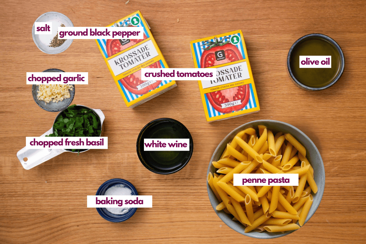 Ingredients needed to make penne pomodoro or pasta with tomato basil sauce.