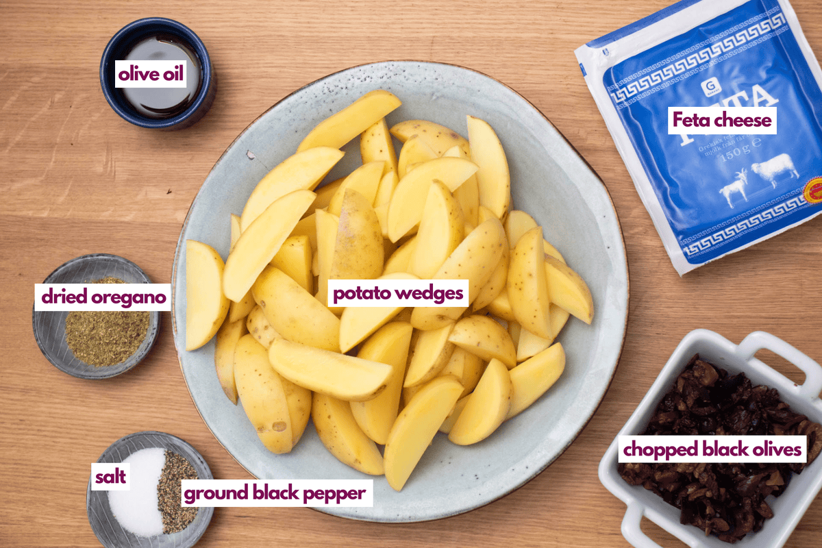 Ingredients needed to make potato wedges with feta cheese and black olives.