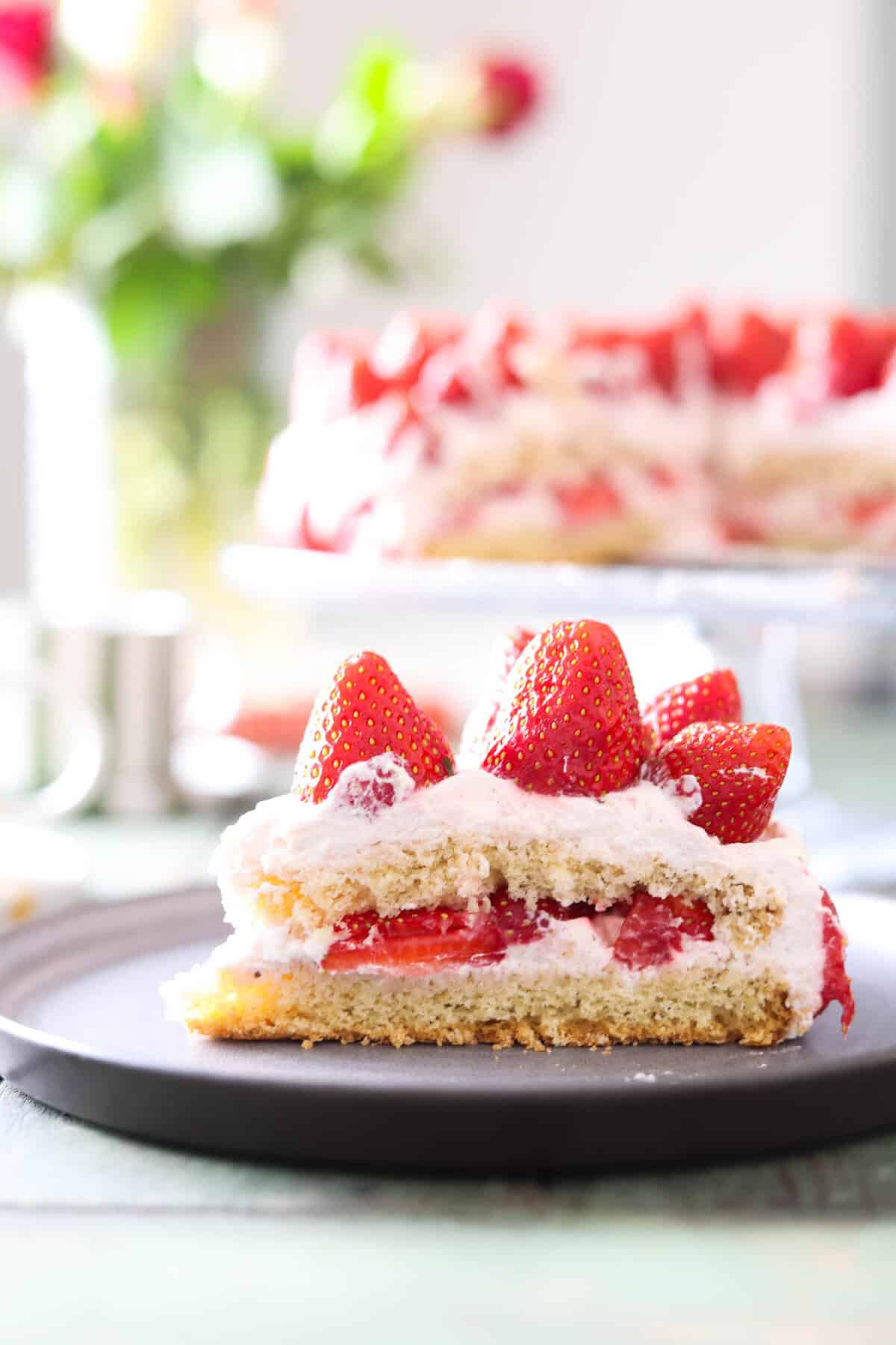 A slice of strawberry cream cake.