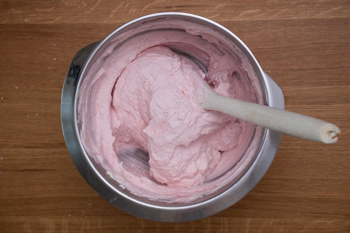 Strawberry whipped cream in a mixing bowl.