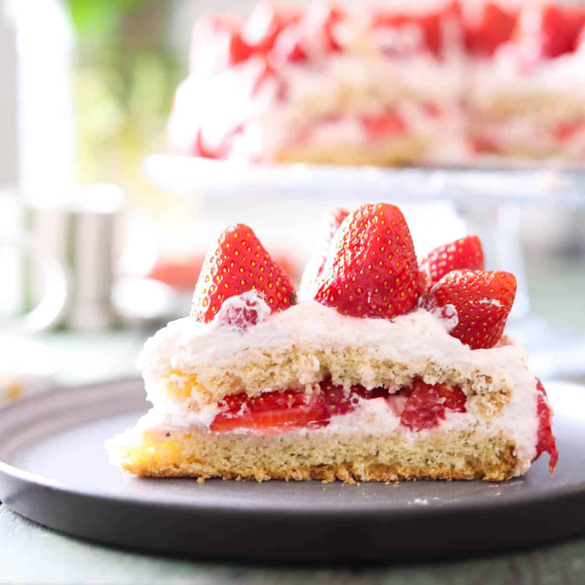 A slice of strawberry cream cake.