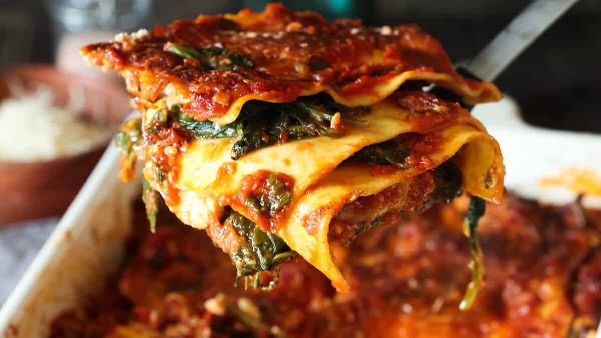 Spinach lasagna with tomato sauce, sun-dried tomatoes and pine nuts.