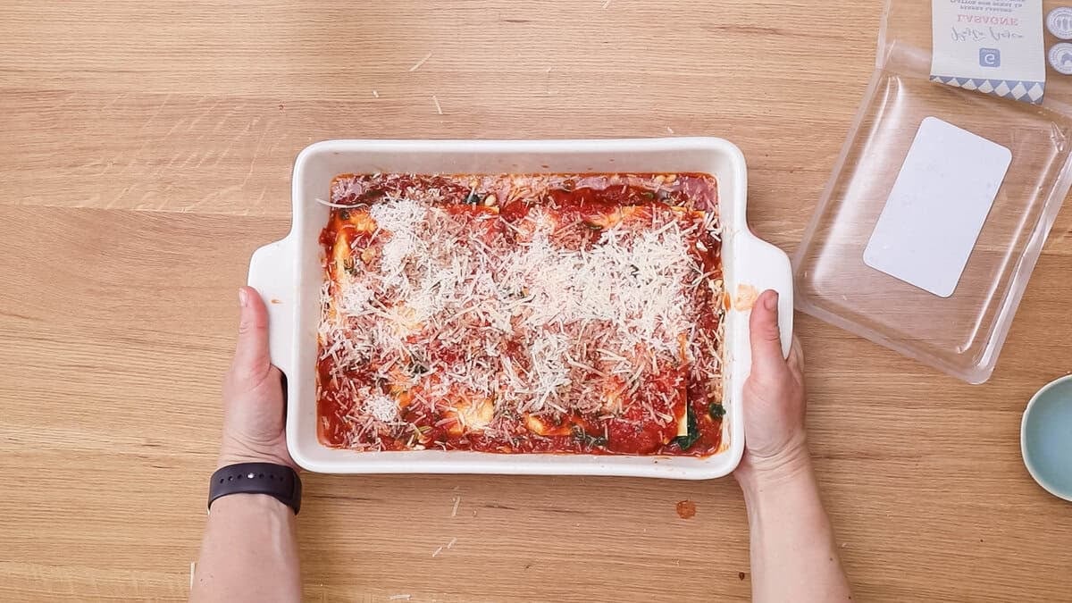 Finished spinach lasagna with pine nuts and sun-dried tomatoes before baking.