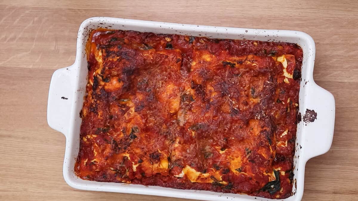 Finished spinach lasagna with pine nuts and sun-dried tomatoes.