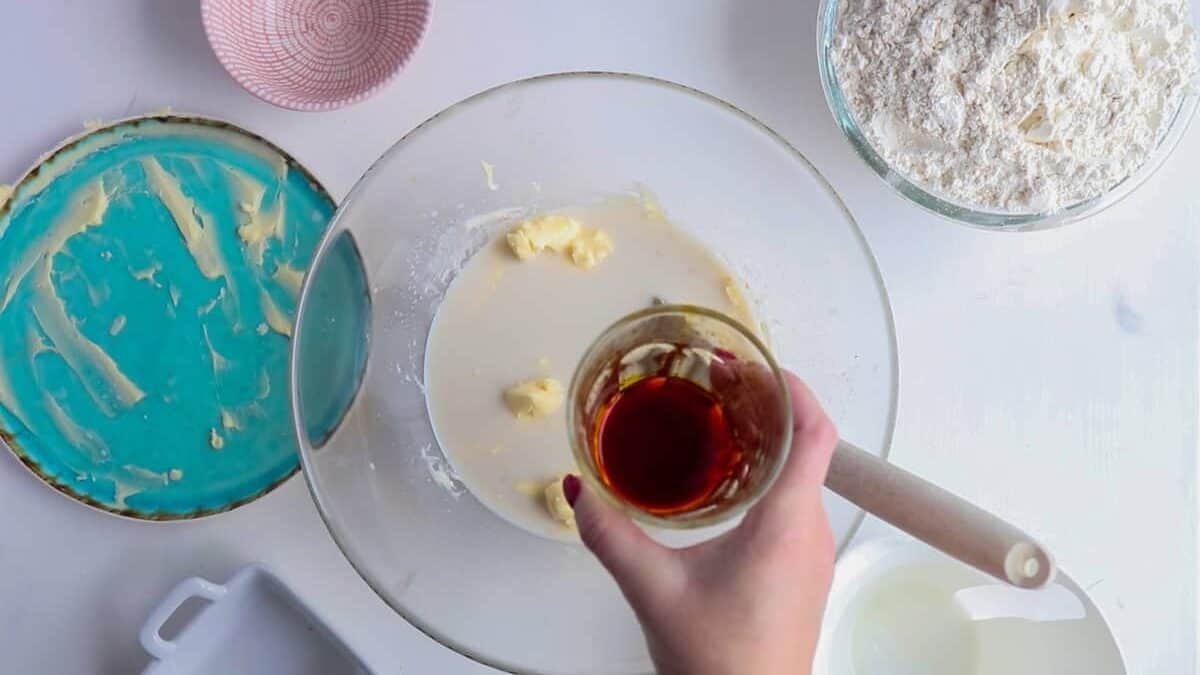 Adding saffron mixed with rum and sugar to the dough to make lussekatter.