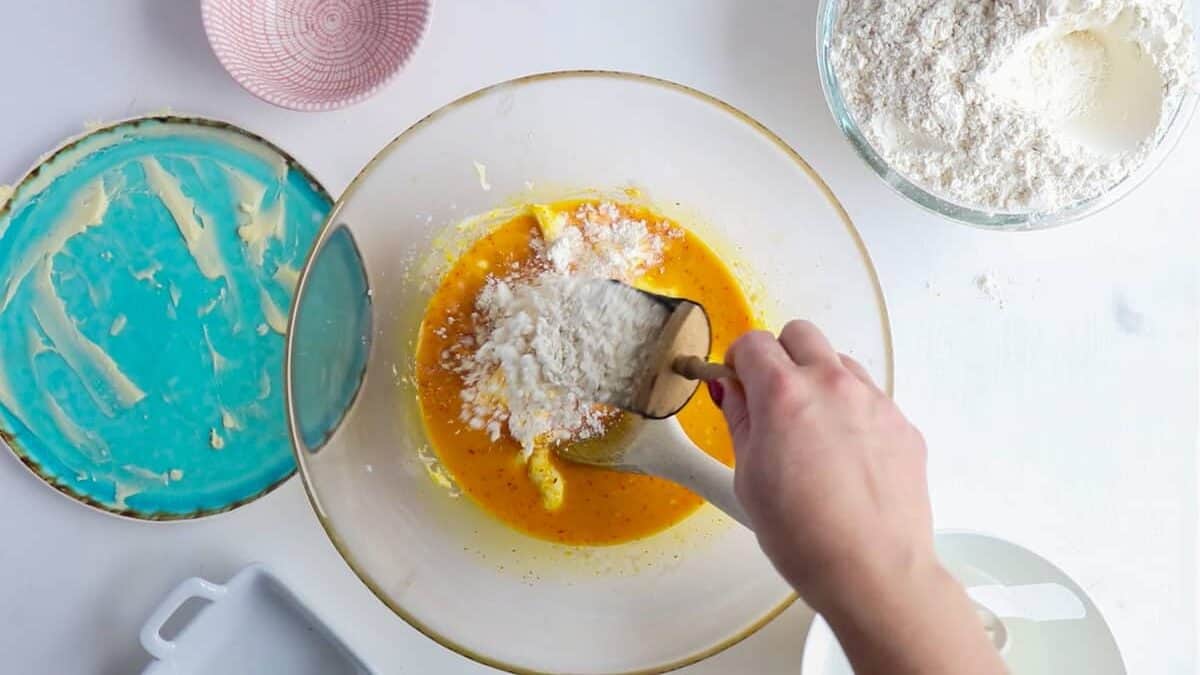 Adding flour to the dough to make lussekatter.